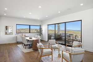 Dining space with wood-type flooring and recessed lighting