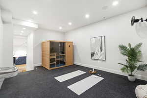 Exercise room with a sauna / steam room and recessed lighting