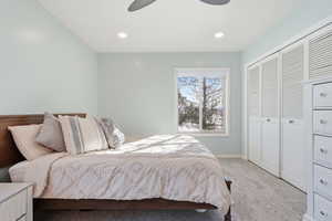 Carpeted bedroom featuring a closet, a ceiling fan, and recessed lighting