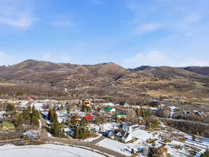 View of mountain backdrop featuring nearby suburban area
