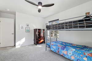 Unfurnished bedroom featuring carpet floors and ceiling fan