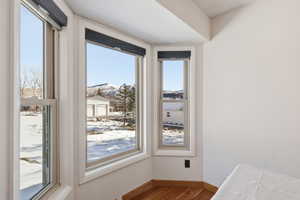 Unfurnished dining area with wood finished floors and a mountain view