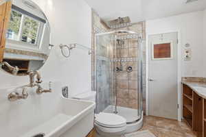 Full bathroom with vanity and a shower stall