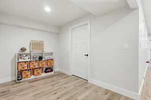 Misc room with light wood-type flooring and baseboards