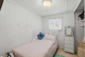 Bedroom featuring wood finished floors and a textured ceiling