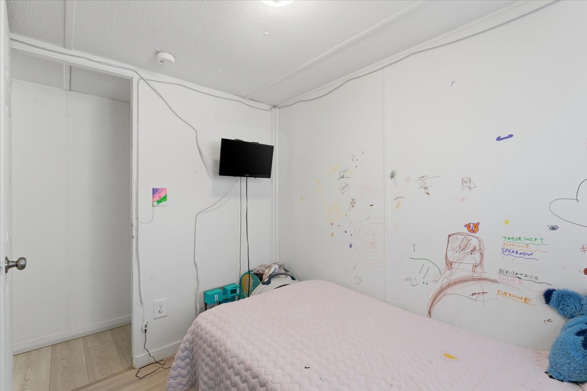 Bedroom featuring wood finished floors and baseboards