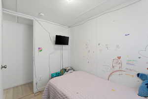 Bedroom featuring wood finished floors and baseboards