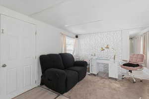 Sitting room with carpet flooring