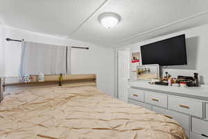 Bedroom featuring a textured ceiling