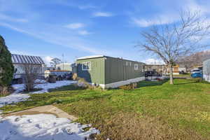 Yard layered in snow featuring a yard