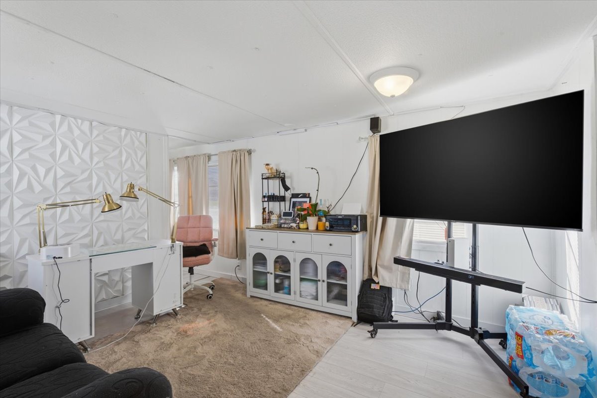 Living area with wood finished floors and baseboards