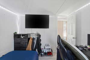 Bedroom with a desk and wood finished floors