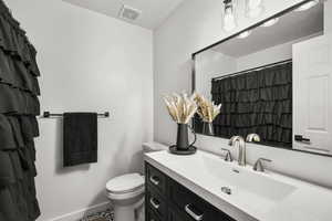 Full bath with vanity, a shower with curtain, and a textured ceiling