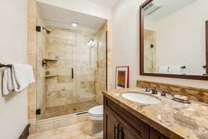 Bathroom featuring vanity and a shower stall