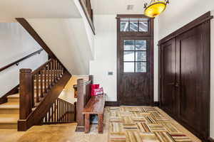 Foyer featuring a high ceiling and stairs