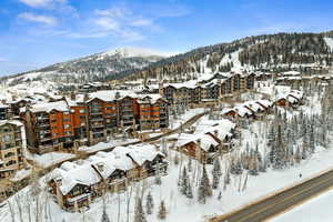 Snowy aerial view featuring a mountain view