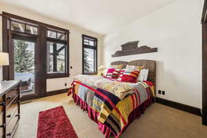 Bedroom featuring carpet flooring and baseboards