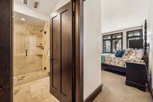 Bathroom with a shower stall, ensuite bath, and light carpet