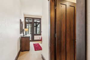 Hallway with carpet floors and a textured wall