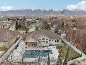 Aerial view of residential area featuring a pool and mountains