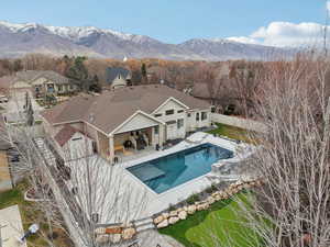 View of pool with a patio area, a fenced backyard, and a mountain view
