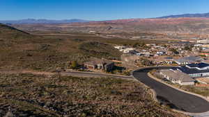 Aerial overview of property's location featuring mountains and nearby suburban area