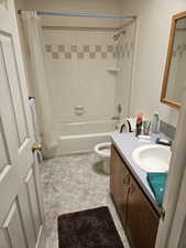 Bathroom with shower / bath combo with shower curtain and vanity