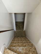 Stairway featuring baseboards