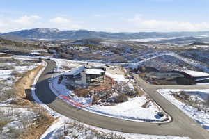 Snowy aerial view featuring a mountain view
