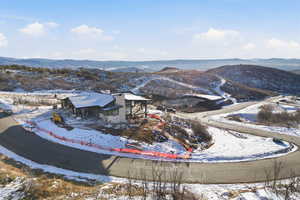 Snowy aerial view featuring a mountain view