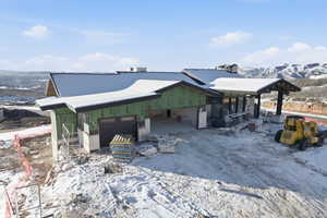 Snow covered structure with a mountain view