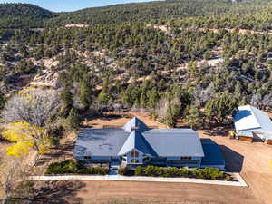View of subject property with a heavily wooded area and a mountainous background
