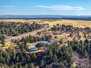 Aerial overview of property's location featuring a mountain backdrop and rural landscape