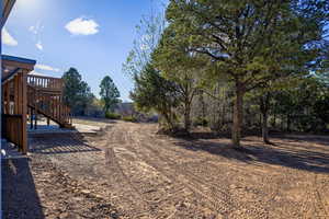 View of yard with stairway and a deck