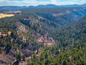 Aerial view of property and surrounding area featuring a mountainous background