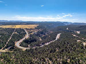 Aerial view of a mountainous background and a heavily wooded area