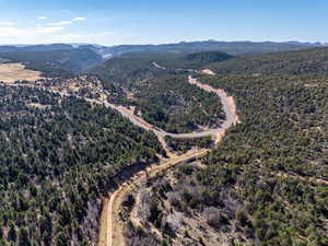 View of property location featuring mountains and a heavily wooded area