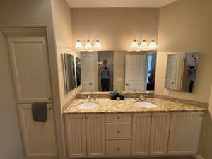 Bathroom with linen closet, double vanity with granite counters &