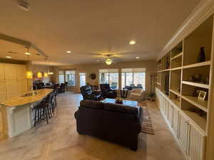 Living area with ceiling fan and recessed lighting