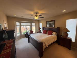 Primary Bedroom with recessed lighting, bay windows, carpet, ceiling fan, and a textured ceiling