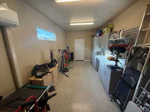 Workshop in the finished the 4th car garage stall is finished, with baseboards, epoxy floors and a wall mounted AC mini-split