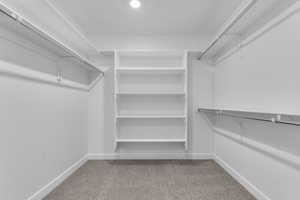 Walk in closet with light carpet