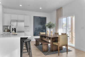 Dining space featuring light wood-style floors and recessed lighting