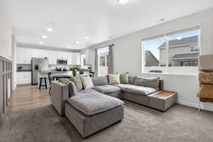 Living area featuring light carpet and recessed lighting