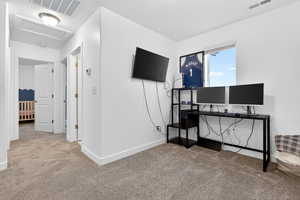 Office featuring carpet flooring and attic access
