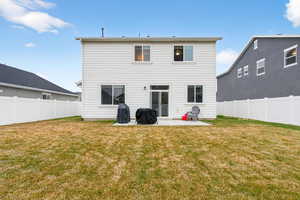 Back of property with a patio area and a fenced backyard