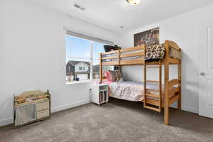 Bedroom featuring carpet and baseboards