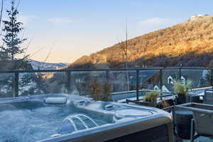 Exterior space featuring a mountain view and a hot tub