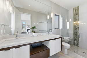 Ensuite bathroom featuring double vanity and a stall shower