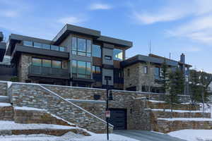 View of front of property with stone siding and stucco siding